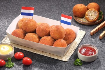 Bitterballen is the name of a type of food in the Netherlands. Bitterballen taste similar to croquettes, but are small round shapes about 3 to 4 cm