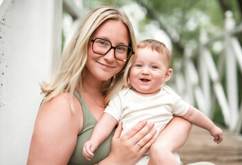 Happy family on a summer meadow. little girl child baby daughter with mother