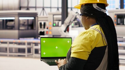 Specialist using green screen laptop to conduct inspection in renewable energy industry 4.0 plant. Technician in photovoltaics smart factory testing equipment using chroma key notebook, camera B