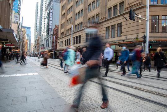 Pedestrians crossing George Street light rail tracks