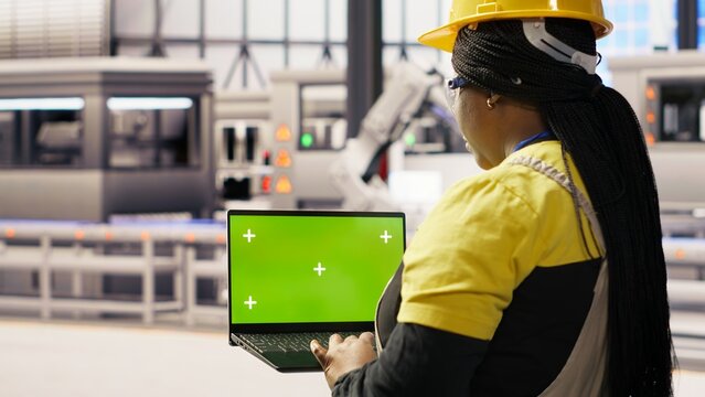 Specialist using green screen laptop to conduct inspection in renewable energy industry 4.0 plant. Technician in photovoltaics smart factory testing equipment using chroma key notebook, camera B