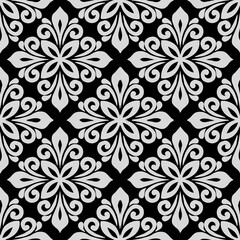 Fototapeta premium Thai fabric pattern, combining the gracefulness of white flowers against a black background, creating a luxurious and charming look, suitable for fashion and home decoration.