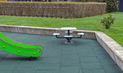 Green Slide Table With Chairs Set at Playground in City Park