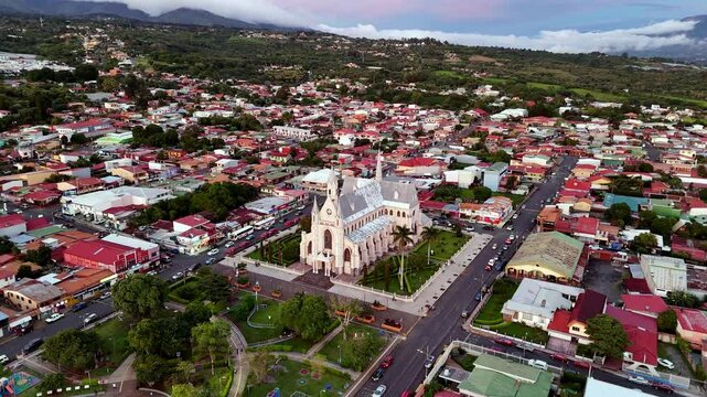 Aerial footage of San Rafael, Heredia, Costa Rica shows its iconic church at sunset