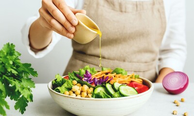 Pouring Salad Dressing on Fresh Vegetable Bowl – Healthy Vegan Meal Preparation