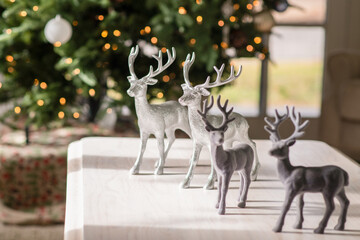 silver and grey reindeer figurines stands gracefully on a white table