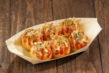 Takoyaki is a food from the Kansai region in Japan. in the form of small balls with a diameter of 3-5 cm made from wheat flour dough filled with pieces of octopus inside