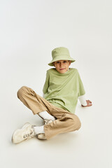 Stylish little boy enjoying a moment of carefree playfulness in vibrant attire