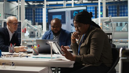 Photovoltaics plant researchers work on breakthroughs in durability and performance in office. Factory experts testing materials for next generation solar panels, doing research and development