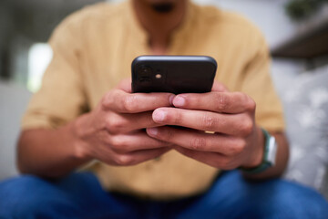 Close-Up of Hands Holding Smartphone at Home in a Relaxing Setting