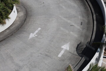 Opposite side sign straight white arrow on gray asphalt and concrete show a direction forward and backward