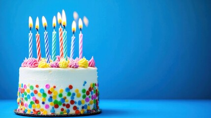 Colorful birthday cake with lit candles