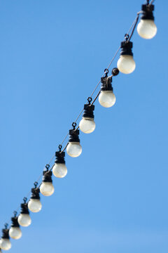 A line of light bulbs hanging in a row