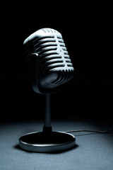 Vintage silver microphone with a black background