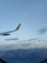 Cloudy Aerial View with Plane Wing and City Below