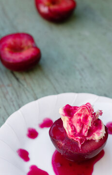 sweet plum with whipped cream and a warm cinnamon plum sauce