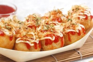 Takoyaki is a typical Japanese snack in the form of small balls made from wheat flour dough and filled with pieces of octopus.