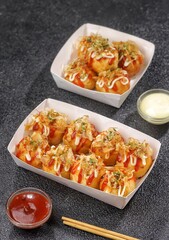 Takoyaki is a food from the Kansai region in Japan. in the form of small balls with a diameter of 3-5 cm made from wheat flour dough filled with pieces of octopus inside