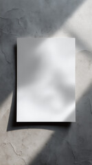 Blank white sheet of paper on texture concrete surface.