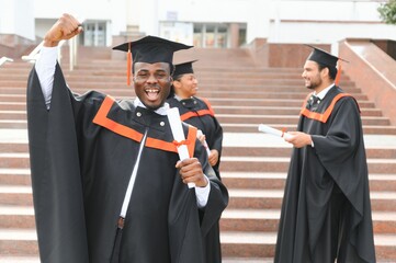 Happy graduate. Happy African man in graduation gowns