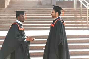 Two friends are university graduates. Indian and African graduates