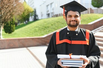 education, graduation and people concept - happy Indian Male graduate student