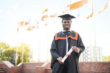 Happy graduate. Happy African man in graduation gowns