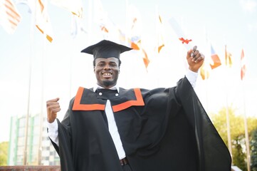 Happy graduate. Happy African man in graduation gowns