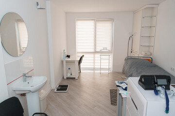Polysomnography Room Setup: Modern Sleep Study Clinic Interior with Monitoring Equipment, Sink, and Bed, Light Wood Tone Aesthetic