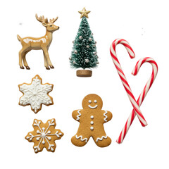 Fototapeta premium A top-down flat lay of Christmas sugar cookie, gingerbread man, peppermint candy canes, porcelain reindeer, and frosted tree with silver stars on white background, under diffused studio light,