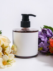 soap bottle with plain white label on bouquet of flowers scene