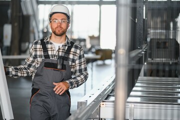Factory worker. Man with helmet working with pvc