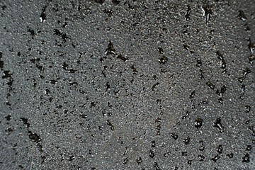 Water droplets on a cast iron macro surface. Cast iron cookware care, rust resistant, abstract pattern