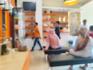 Blur focus of elegant salon interior with modern furnishings, filled with clients waiting for their...