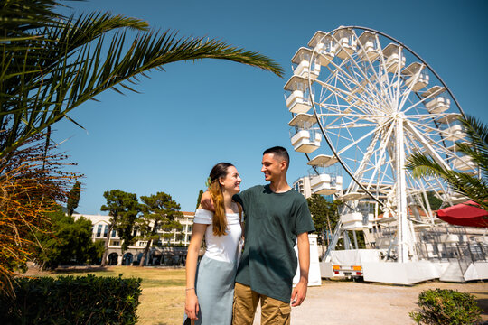Romantic Couple by the Ferris Wheel on a Summer Day - Powered by Adobe
