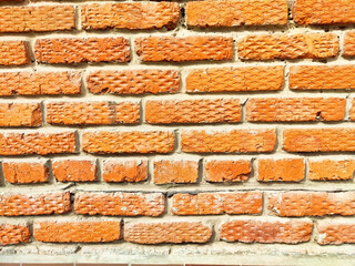 Textured orange brick wall suitable for various design projects