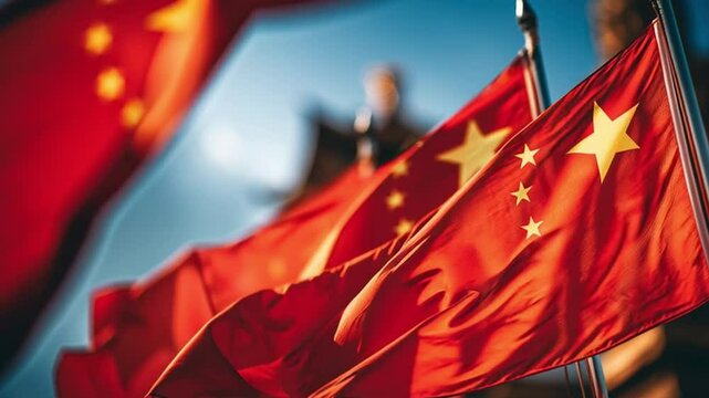 Red Flags in the Wind: A patriotic and evocative image of red flags with golden stars waving proudly against a bright blue sky, symbolizing unity and national identity.