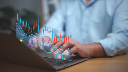 Businessman analyzing financial charts and stock market data on a laptop with candlestick graphs and digital analytics. Focus on investment, trading strategy, financial growth, decision-making.