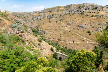 View across canyon landscape with trails and caves