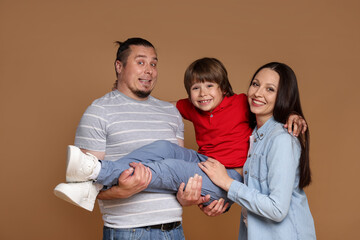 Portrait of happy family on brown background