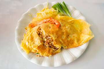 Traditional thai street food Pad Thai or Padthai cuisine meal thai style stir fried rice noodles with egg and vegetable mix spices sauce and shrimp at local restaurant cafe shop in Bangkok, Thailand