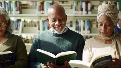 diverse group of elderly people engrossed in reading books in modern, sunlit library, with shelves full of colorful books in the background. senior activity, leisure, hobbies and communication