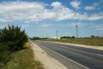 Fototapeta premium A road with grass and trees on the side