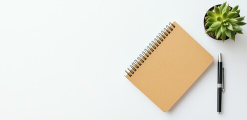 A simple workspace setup with a notebook, pen, and succulent plant. Perfect for focus and productivity.