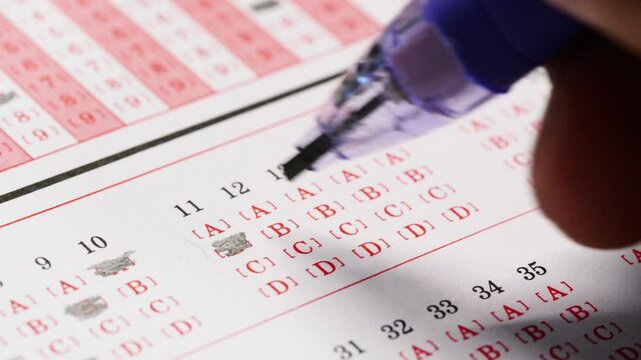 Chinese students fill in answer sheets during exams