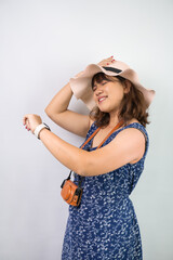 Shocked young asian tourist woman wearing blue summer dress and hat is staring her smartwatch...