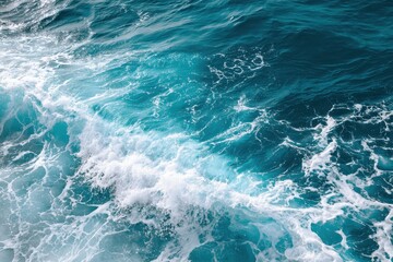Pure blue turquoise water texture of the ocean sea with foam from and waves. MZ 