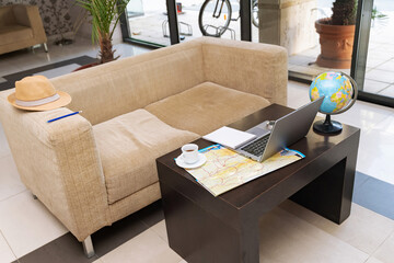 Planning travel adventures with a map and laptop in a cozy cafe setting