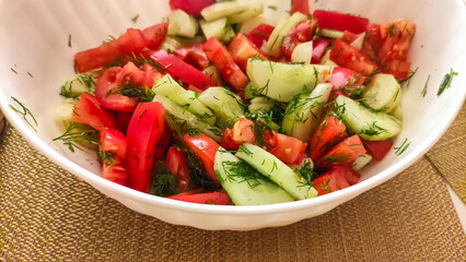 Fresh tomato and cucumber salad with dill in a white bowl healthy dinner