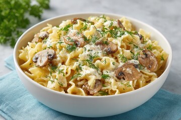 flat-lay of gluten-free pasta with mushrooms and dill sauce in white bowl on pastel table